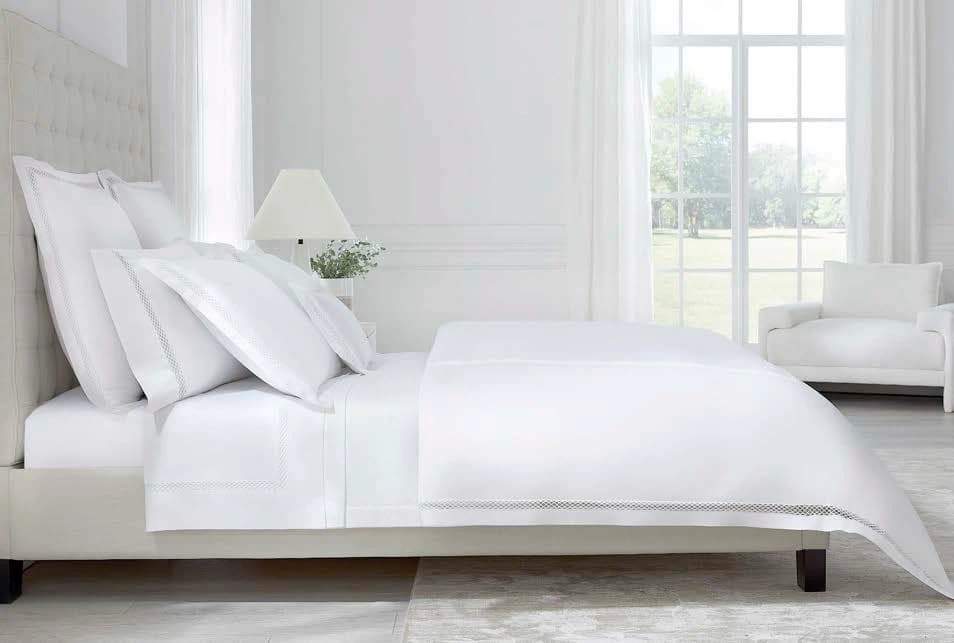 Sferra Murano white cotton sateen bedding on a hotel bed