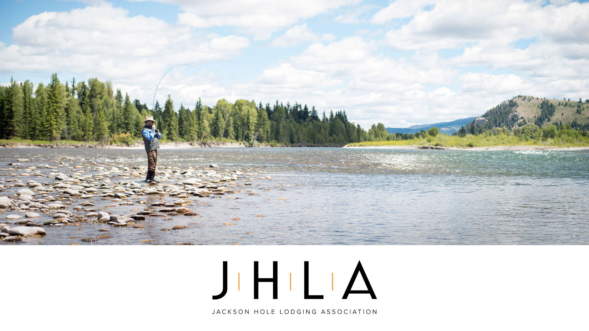 Picture of a man fly fishing in Jackson Hole, Wyoming with the logo for the Jackson Hole Lodging Association.