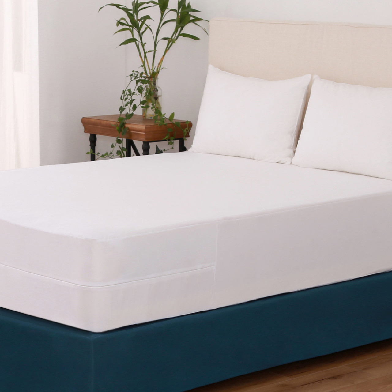 Protextile Mattress Encasement featured with white pillows and light wooden accents.