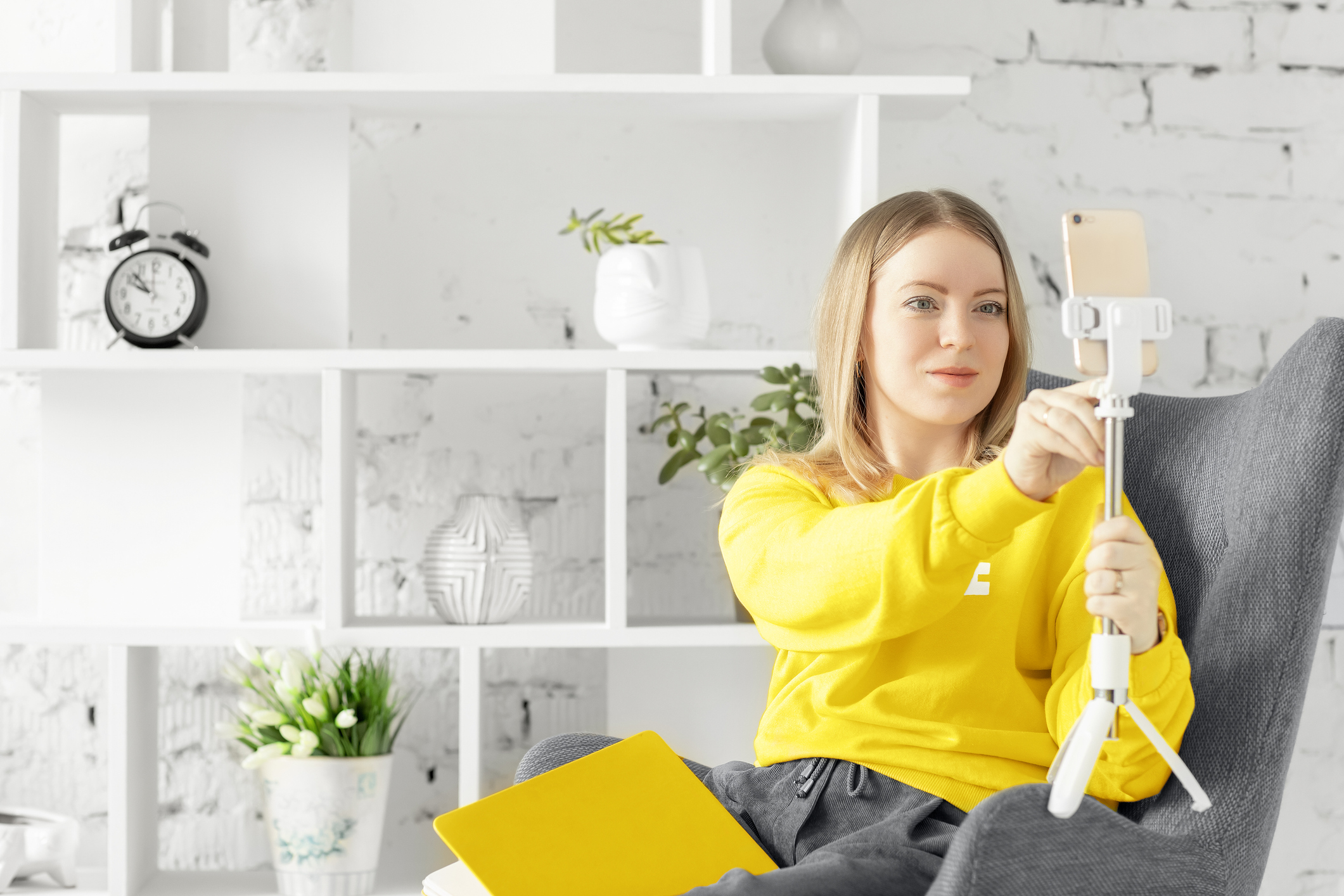 Woman taking selfie picture in home