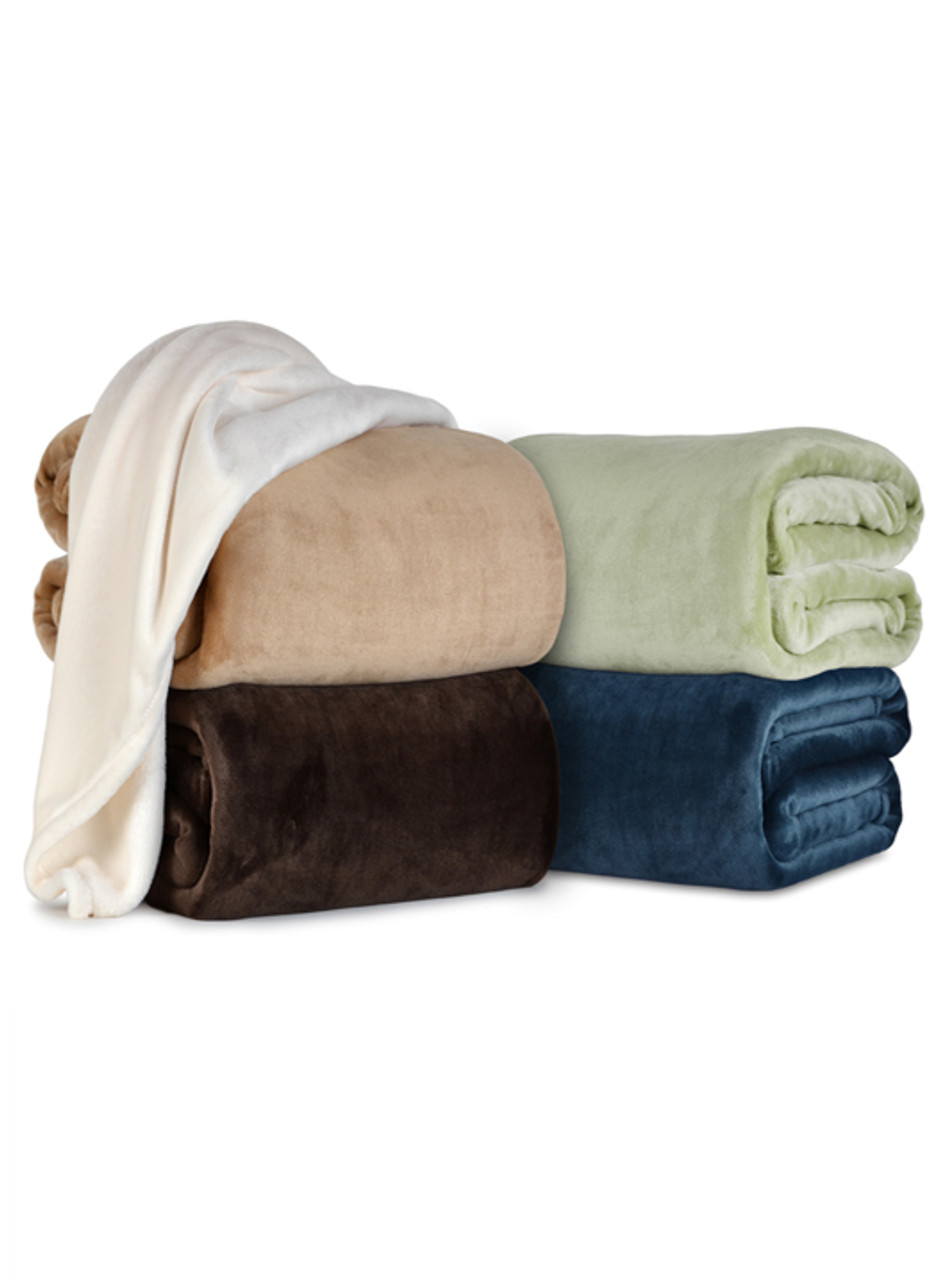 Four folded VelvetLoft plush blankets in four different colors stacked next to one another with a fifth blanket of a fifth different color draped along the top of the others.