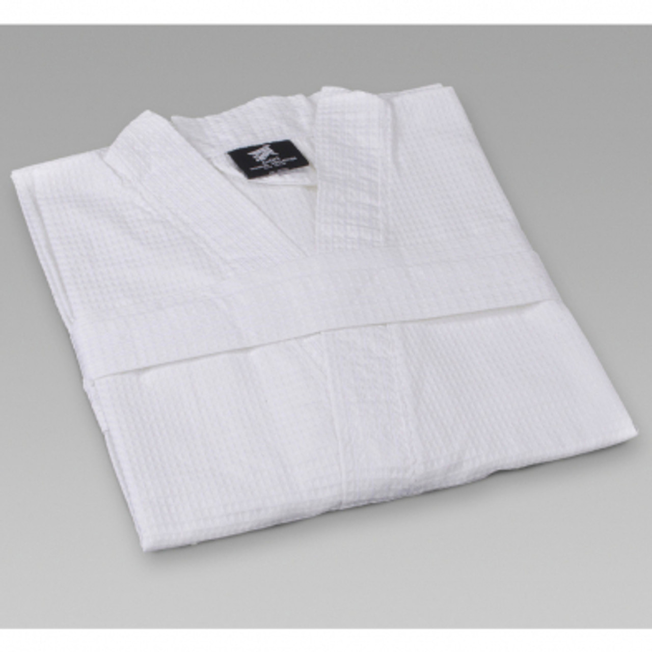 Single white folded waffle weave kimono-style robe.